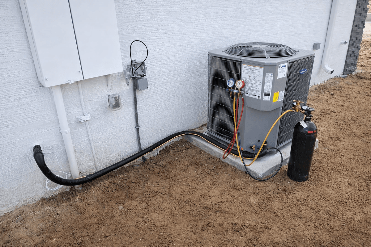 HVAC technician servicing an outdoor condenser unit